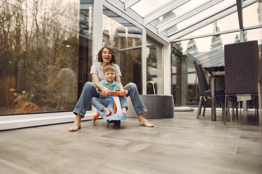 Family enjoying a spacious home addition sunroom built by Nova Construction and Remodeling