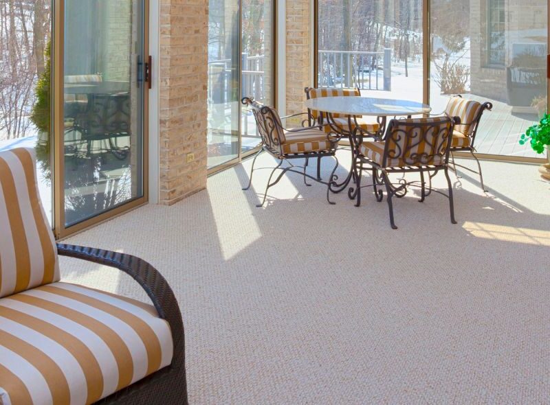 Bright furnished sunroom addition with floor to ceiling windows in Mid Missouri home